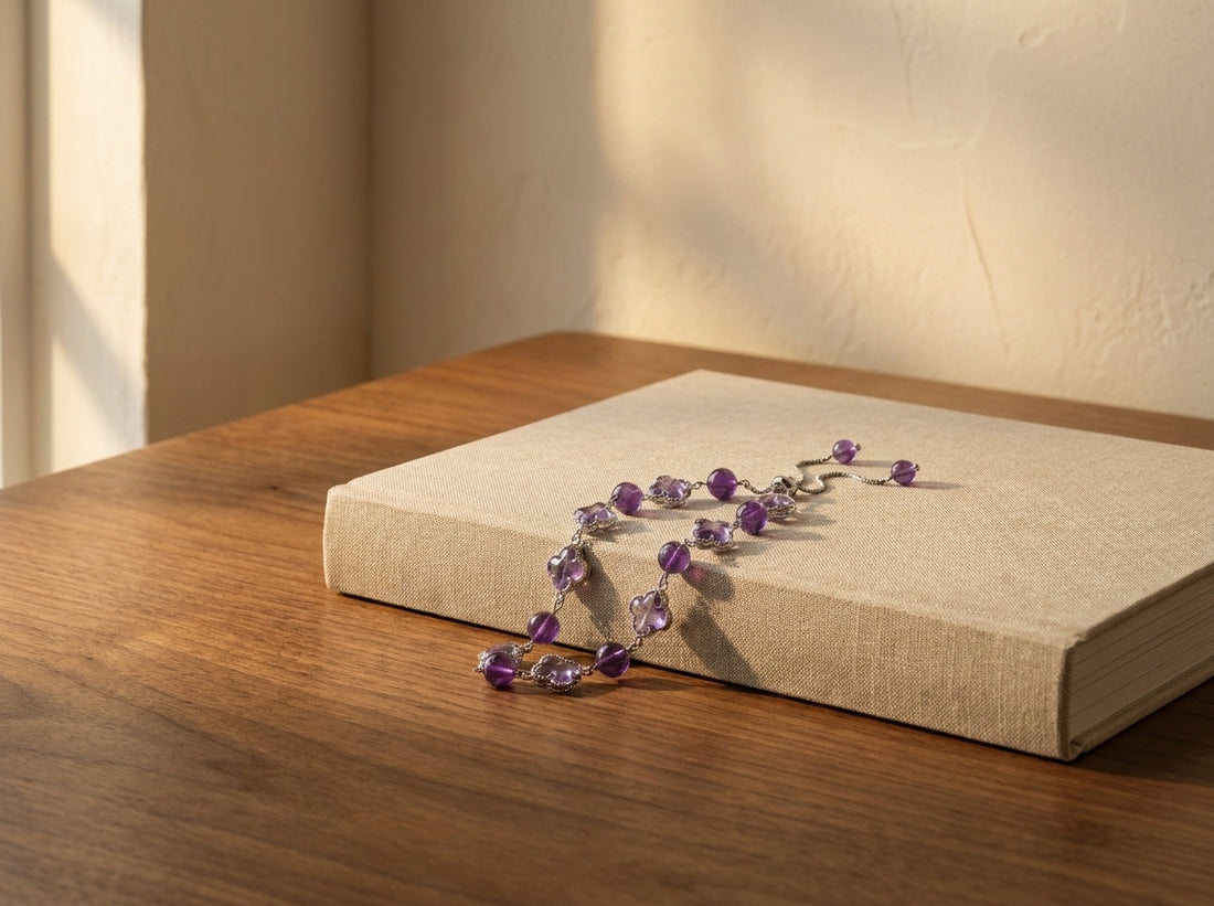 amethyst bracelet laid on a closed book on a calm wooden table