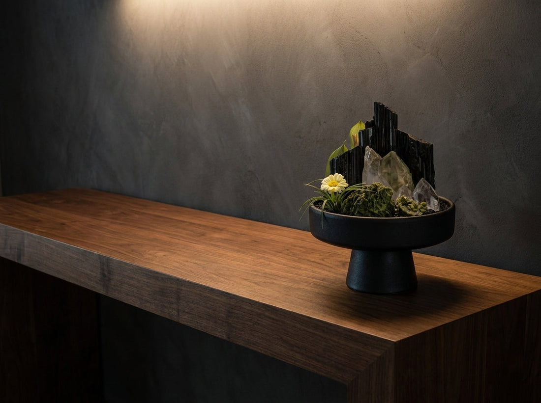 black tourmaline crystal garden on a dark wood console in warm light