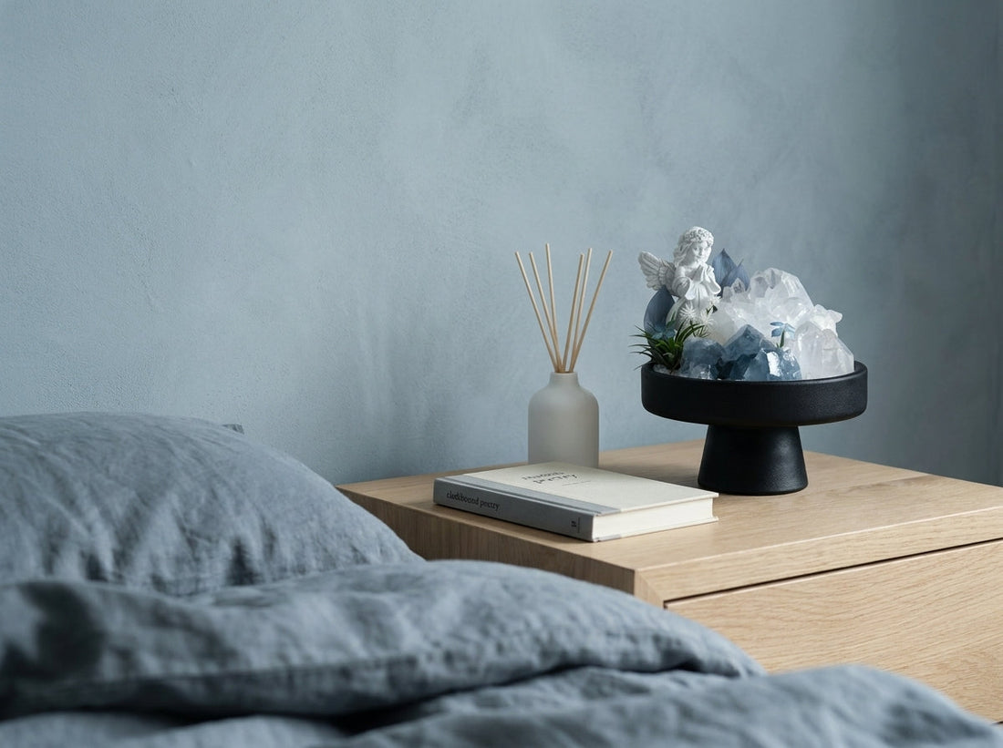 celestite crystal sanctuary on a pale side table by a grey-blue bedroom