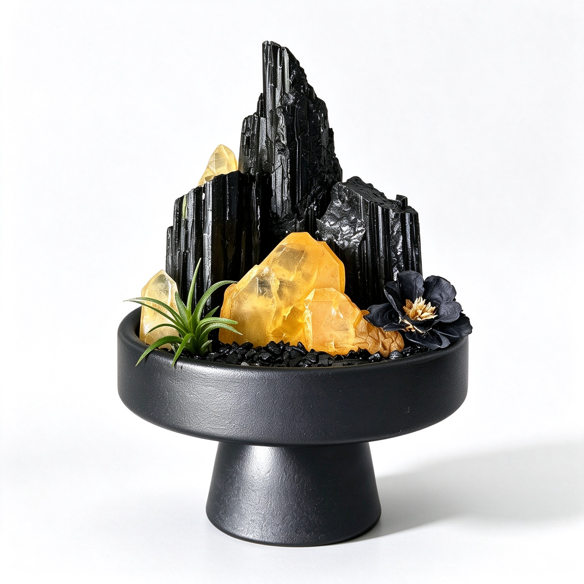 one-of-one crystal garden with black tourmaline, golden healer crystal, air plant; front view on pure white background.
