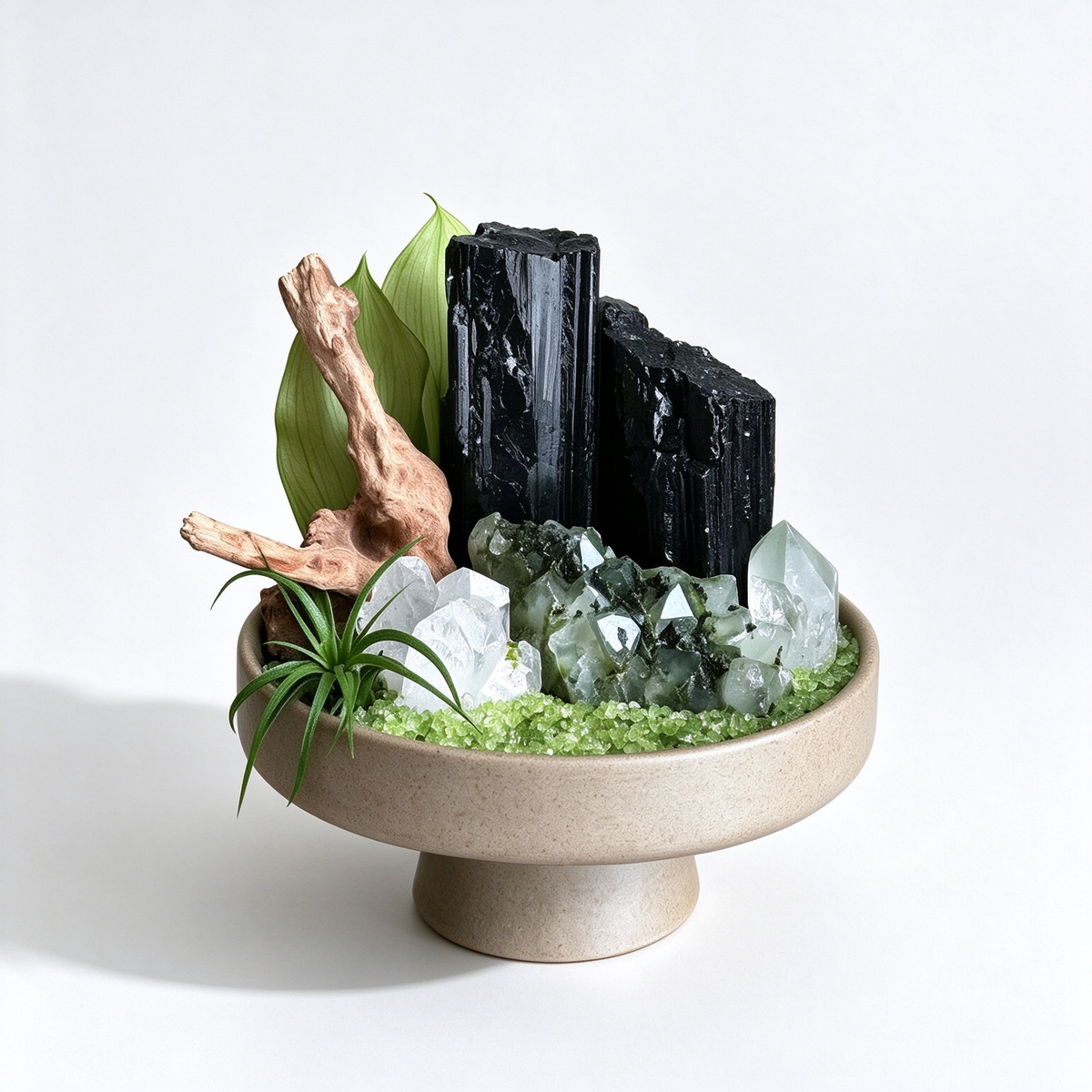 one-of-one crystal garden with black tourmaline, green phantom quartz, clear quartz, air plant; front view on pure white background.

