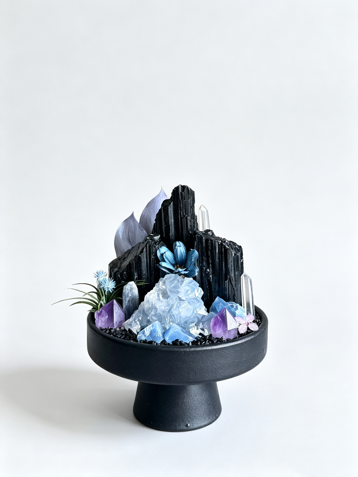 one-of-one crystal garden with black tourmaline, blue celestite, amethyst, blue kyanite, air plant; front view on pure white background.
