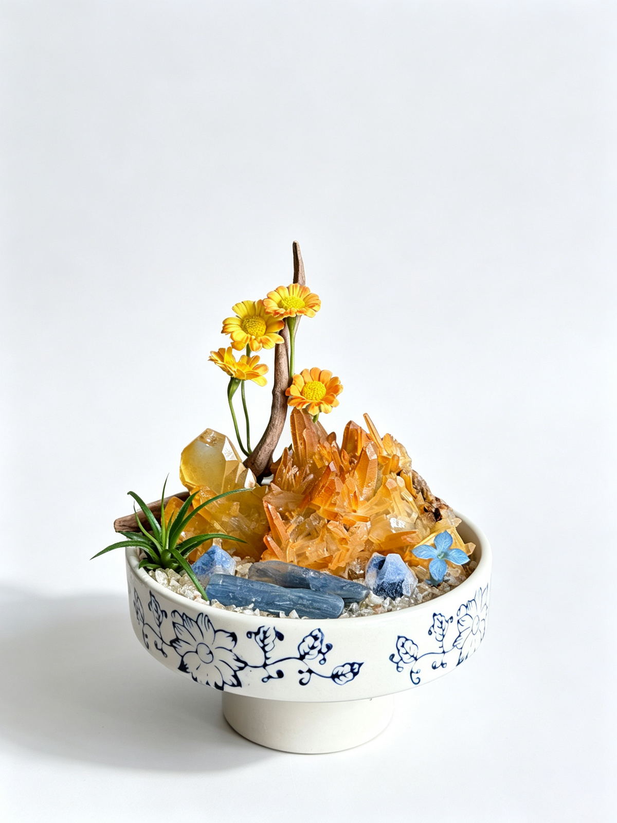 one-of-one crystal garden with golden citrine, blue kyanite, air plant; front view on pure white background.