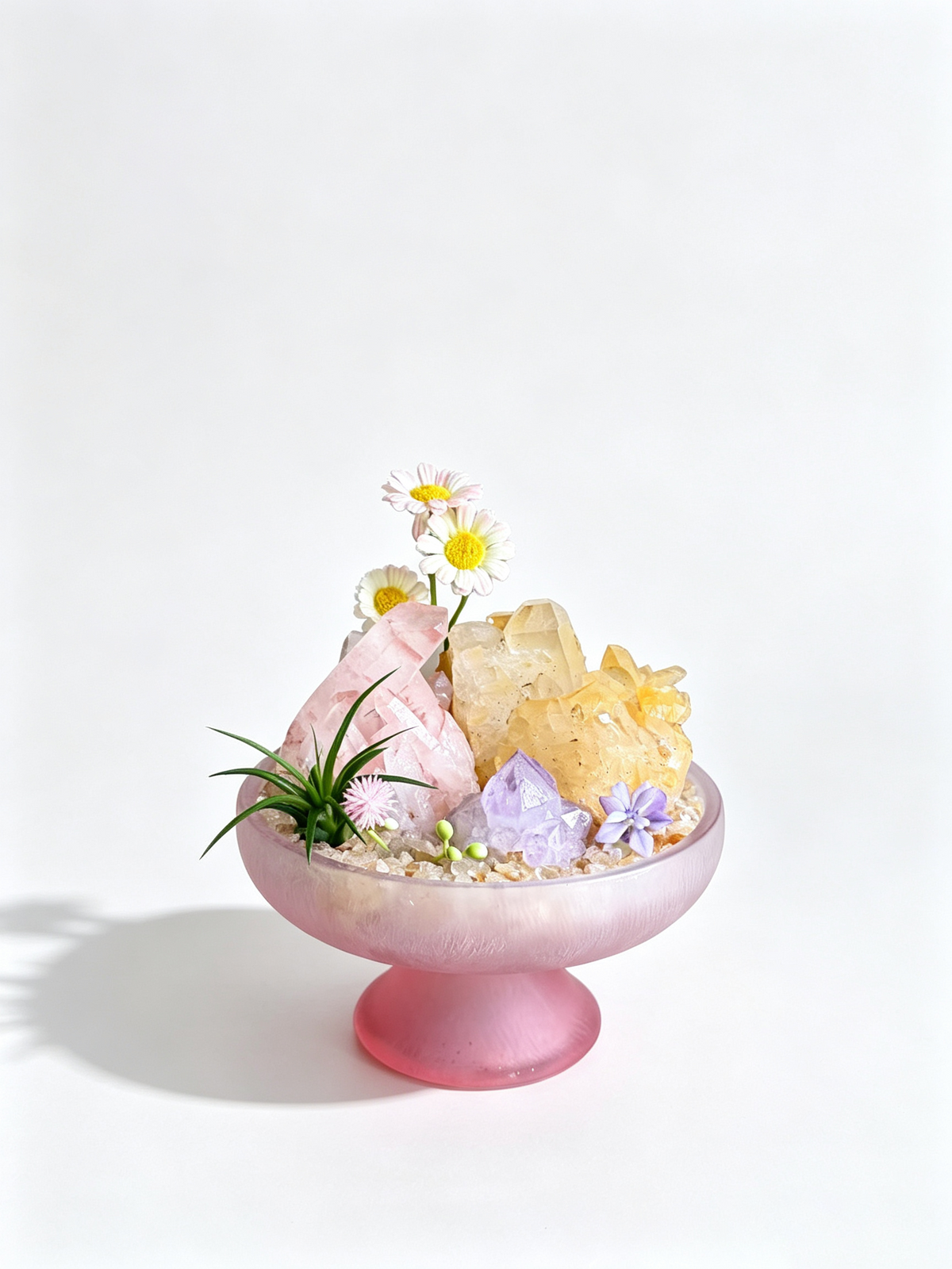 one-of-one crystal garden with golden healer block, rose quartz, amethyst, air plant; front view on pure white background.
