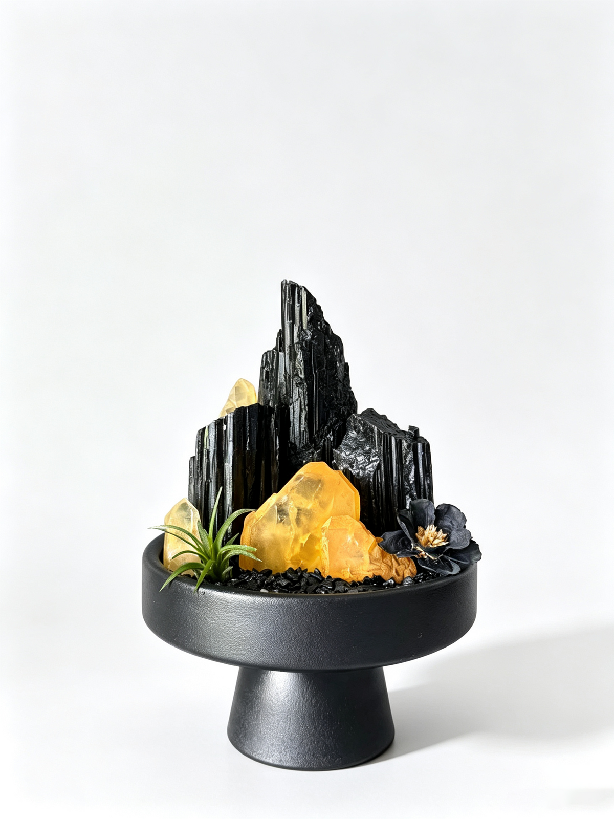 one-of-one crystal garden with black tourmaline, golden healer crystal, air plant; front view on pure white background.
