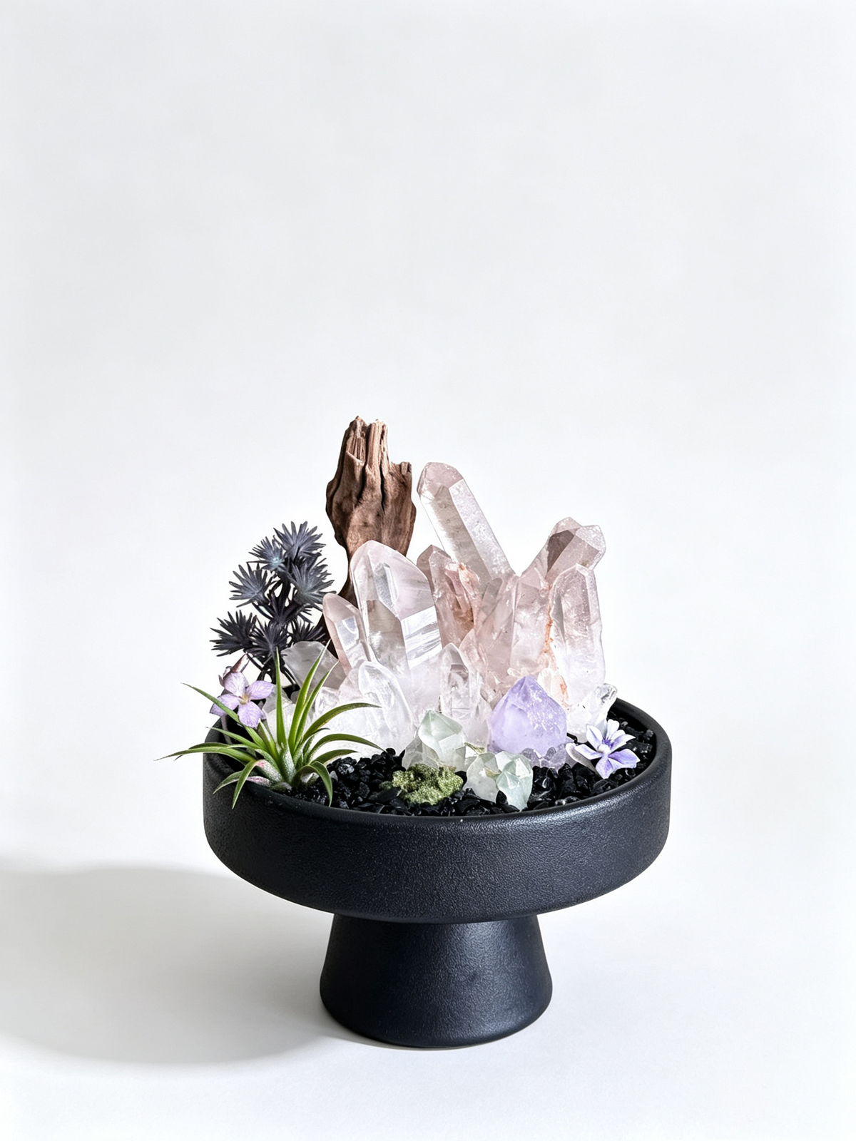  one-of-one crystal garden with smoky rose quartz, driftwood, amethyst, black tourmaline chips, air plant; front view on pure white background.
