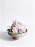 one-of-one crystal garden with white & rose quartz pillars, pink opal, amethyst, air plant; front view on pure white background.
